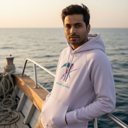 Model wearing the organic Hoodie in Lilac with the Blanket Octopus design by seablub, standing on a boat at sea during early evening light