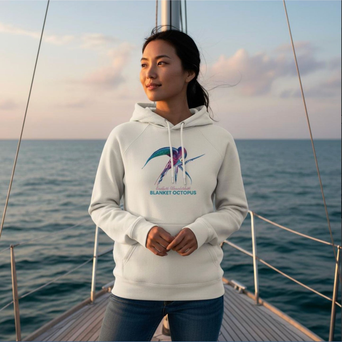 Woman wearing the organic Hoodie in Off-White with Blanket Octopus design by seablub on a sailing boat at sea