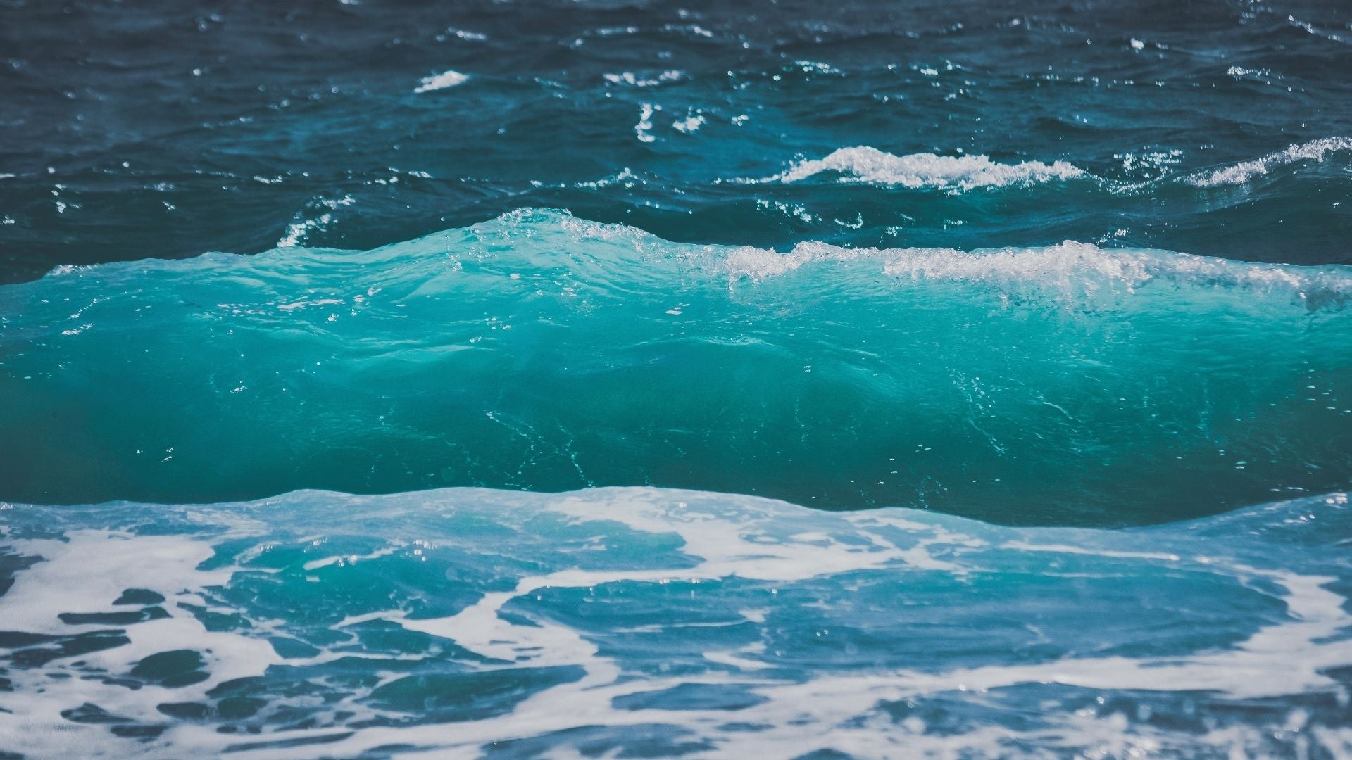 Ocean wave background in turquoise and deep blue tones used as a seablub interface background