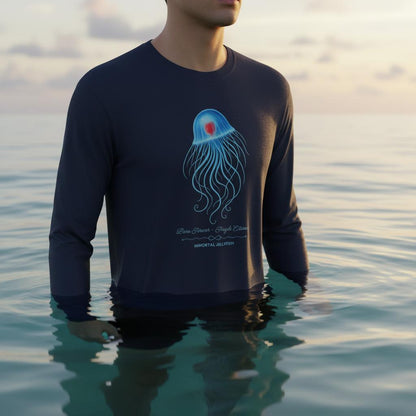 Man standing in the ocean wearing the unisex bio T-Shirt with the Immortal Jellyfish design by seablub in French Navy